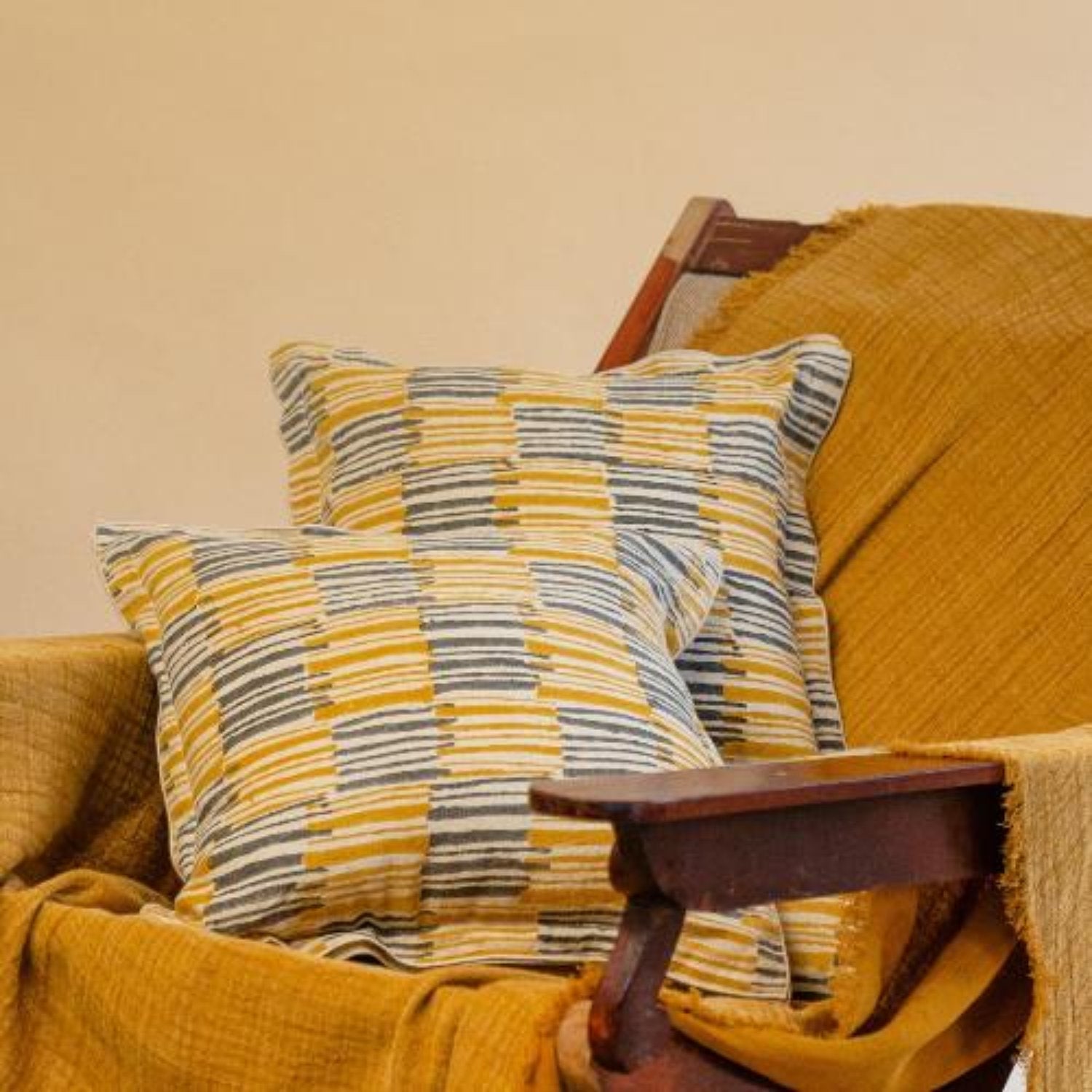 Front view of the Ochrewood hand block printed linen cushion cover in mustard ochre, displayed against a white background.