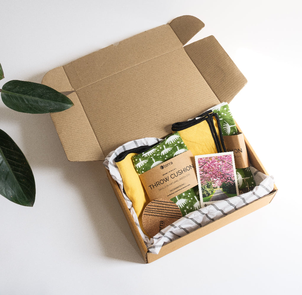 A gift hamper of set of 4 cushions including two yellow and two hand block printed cushions in green