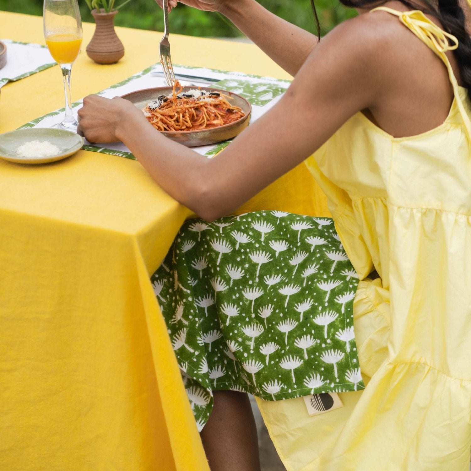 Summer yellow linen tablecloth on a 6-seater table styled for a casual brunch.