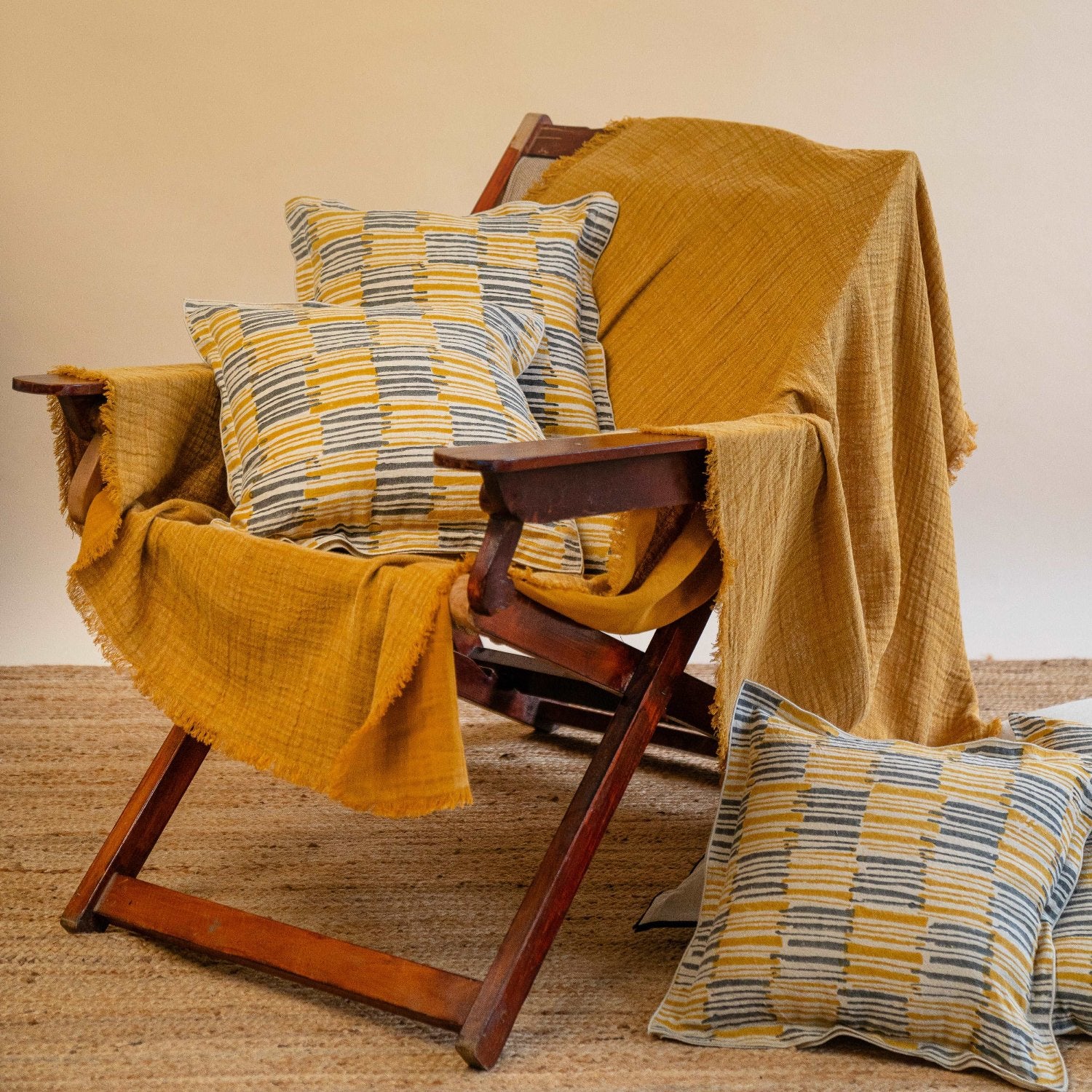 The Ochrewood cushion cover placed on an outdoor patio chair, demonstrating its versatility in both indoor and outdoor settings.