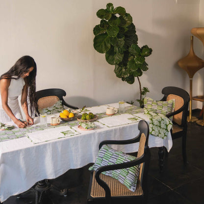 Minimalistic table setting featuring a solid white linen tablecloth.