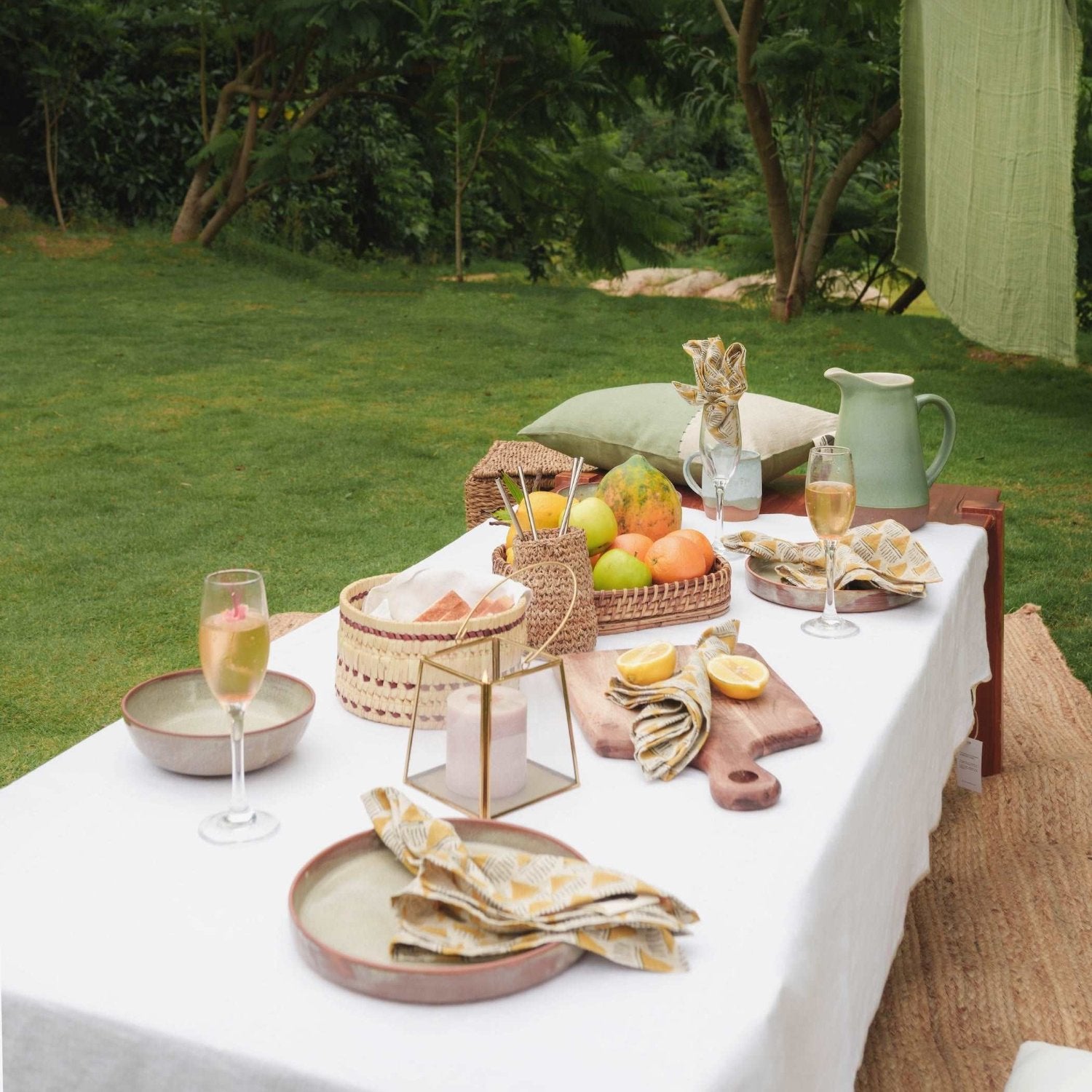 White linen tablecloth styled for a special occasion, paired with candles.