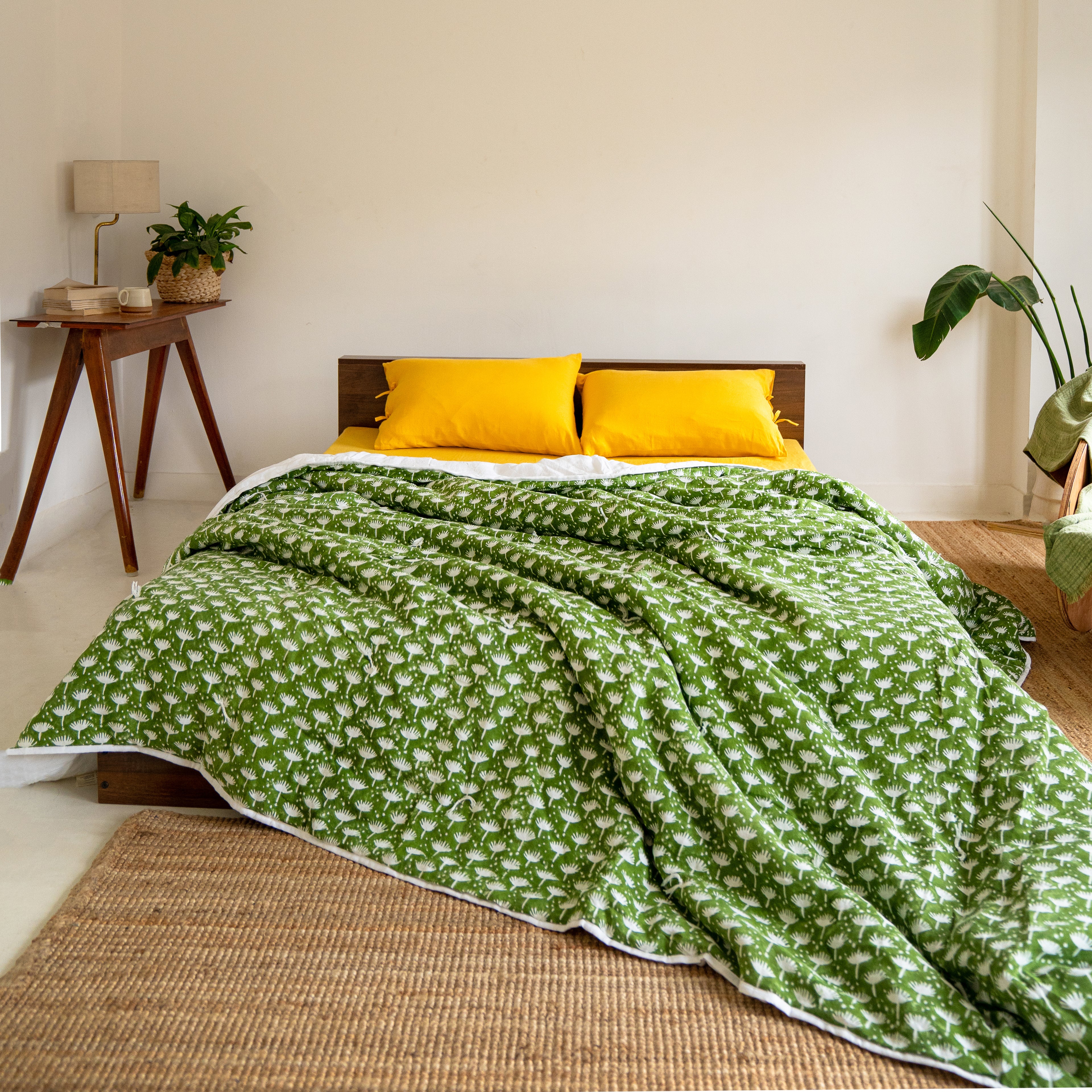 Cozy bedroom featuring the Dahlia quilt styled with bright accents