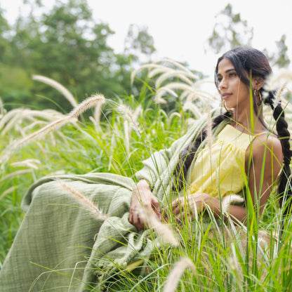 A model looking majestic in the fields draping the double layered throw blanket by Terra.