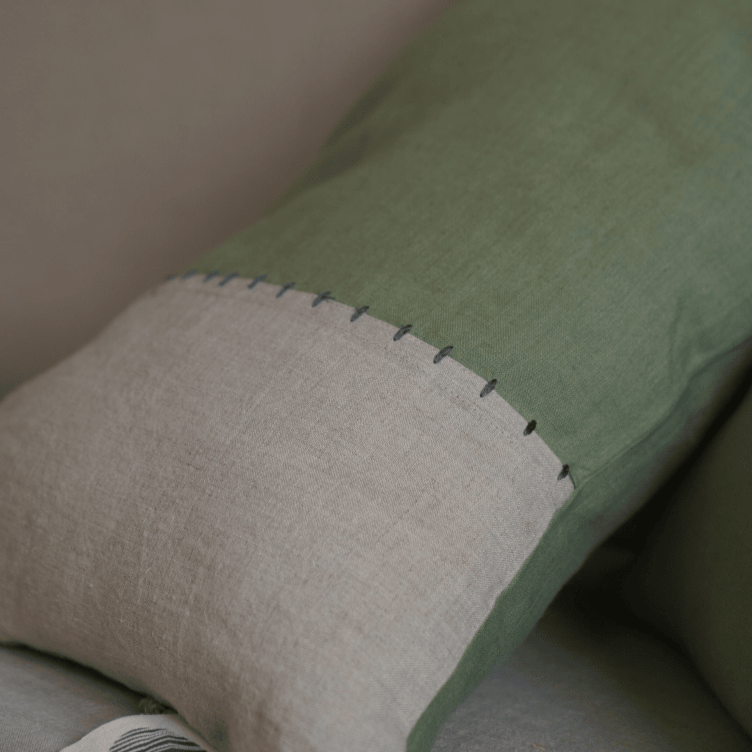 A zoom in image highlighting the rick texture of the fabric and the soothing symphony of neutral pastel colours of green and beige.