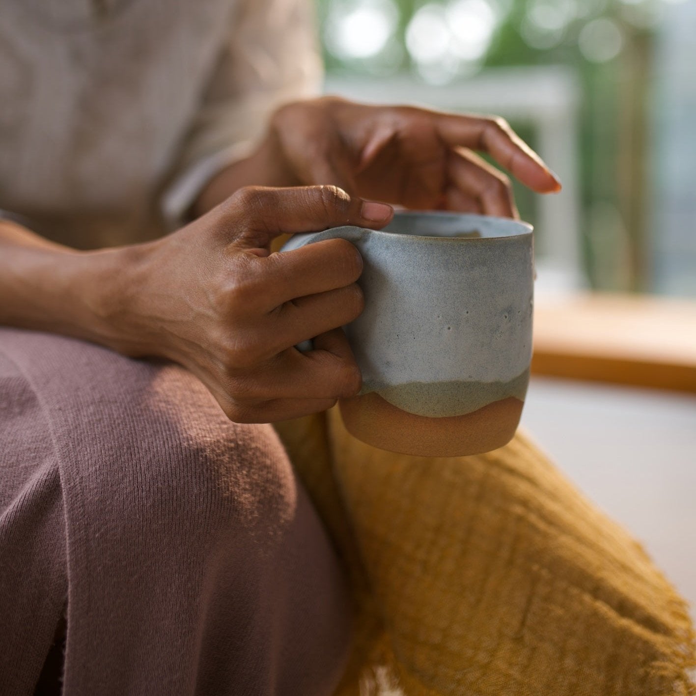 Artisanal coffee mug in cloudy blue glaze, showcasing its unique handcrafted design.