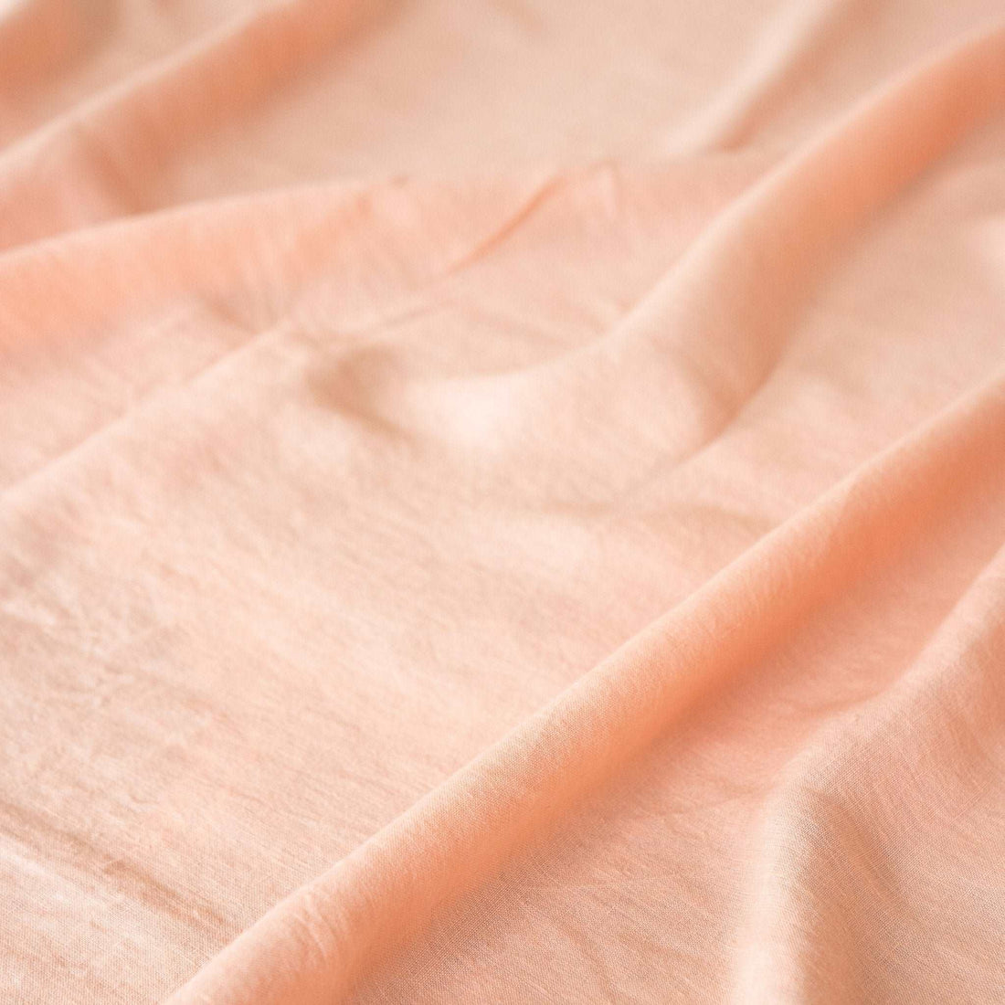 Close-up of pre-washed pink linen sheet for a natural look.