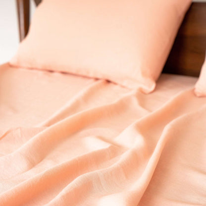 Close-up of pink linen sheet showcasing soft texture.