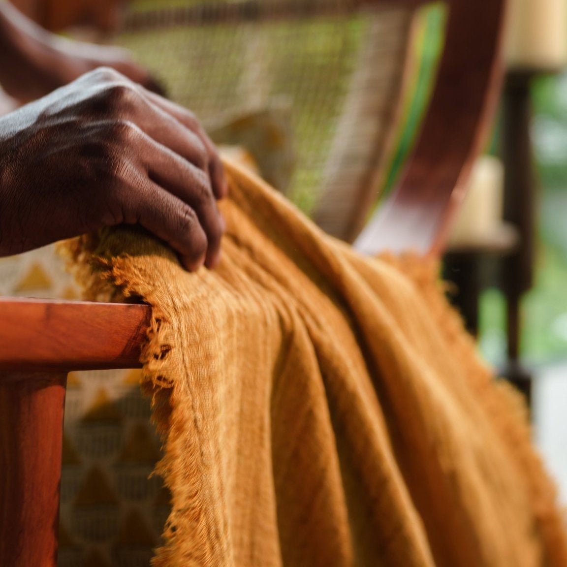 Close-up of the hand-pulled fringe detailing on Mustard Ochre throw blanket