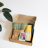 The gift hamperincludes a throw blanket in sage green and a yellow oblong linen cushion along with free goodies; sustainable luxury gifting option