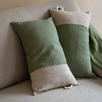 Front view of the oblong linen cushion cover featuring a half olive green and half sand beige design, displayed against a neutral background.