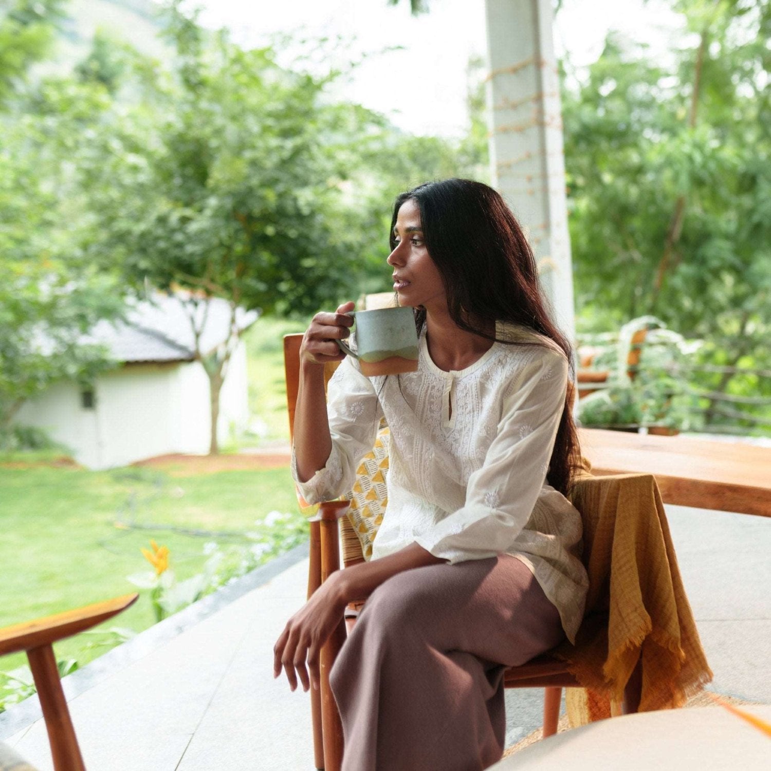 Landscape coffee mug with a serene cloudy blue finish styled with breakfast items.