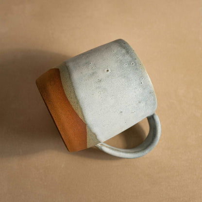 Close-up of the cloudy blue glaze texture on the landscape coffee mug.