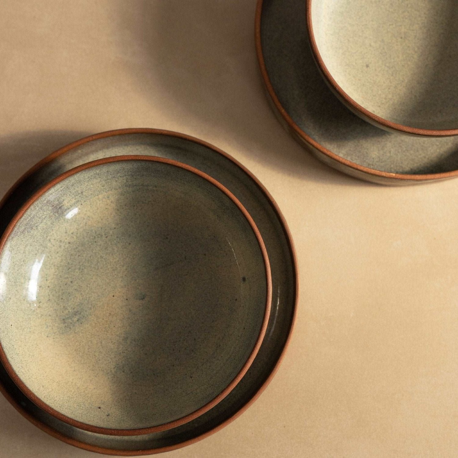 Hand-glazed green speckled bowl, emphasizing its artisanal finish and earthy tones.