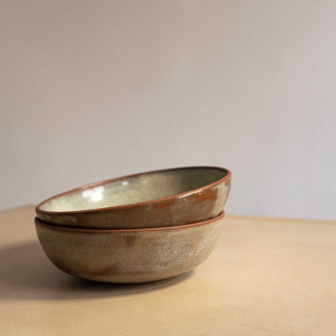 Hand-constructed green speckled bowl showcasing its unique craftsmanship.