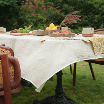 Close-up of the natural linen tablecloth texture showcasing its fine weave.