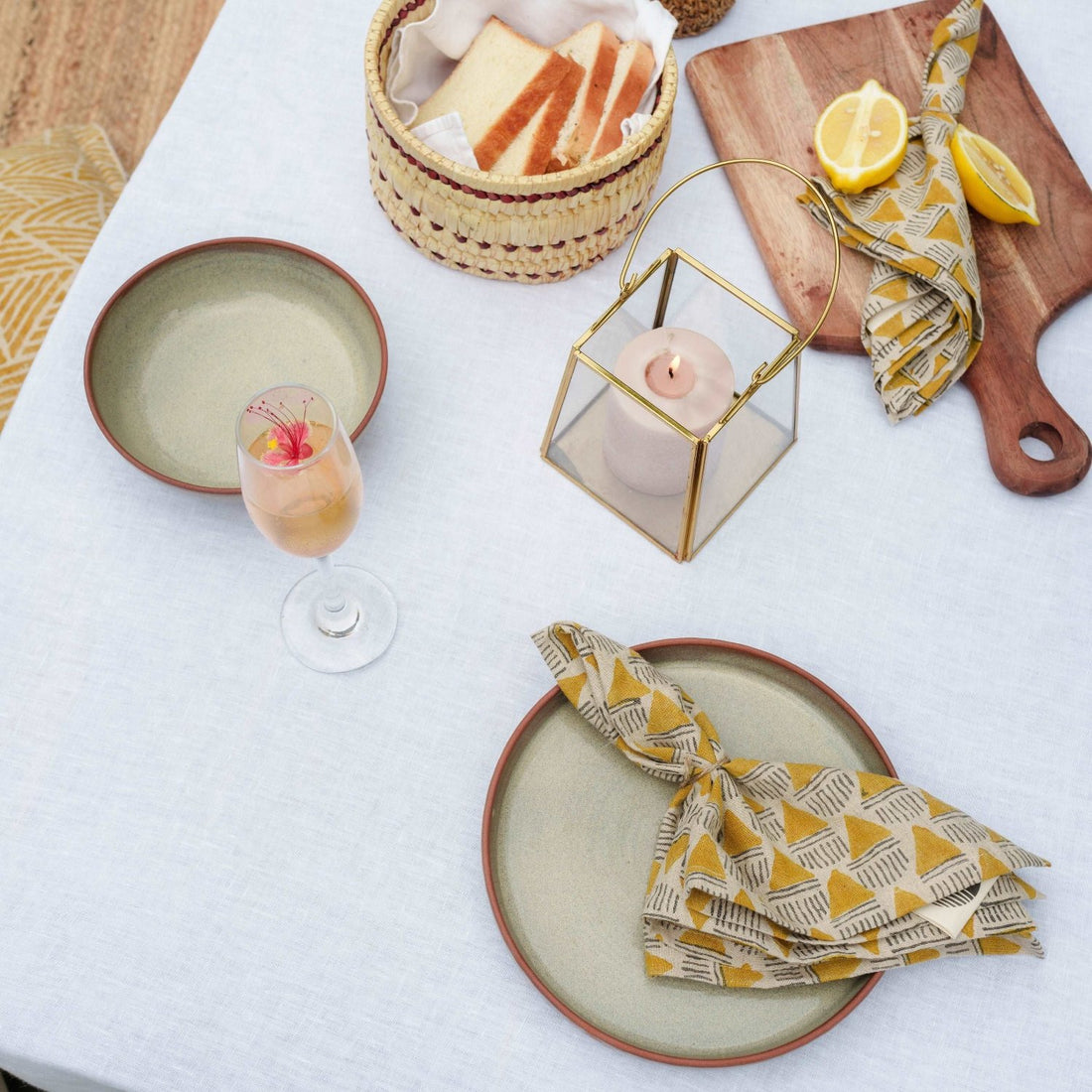 Minimalistic table setting featuring a solid white linen tablecloth.