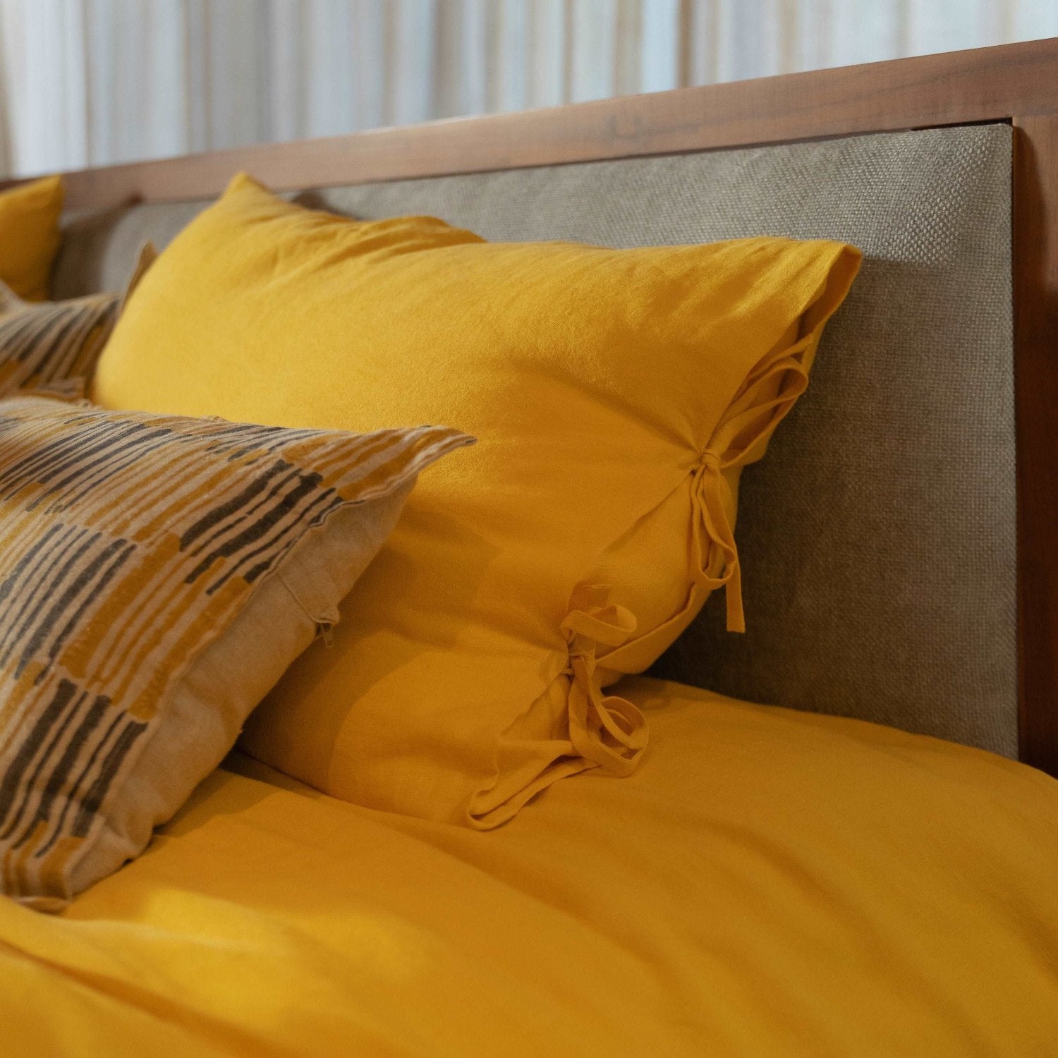 Flat-lay of yellow sheet set with matching pillowcases.