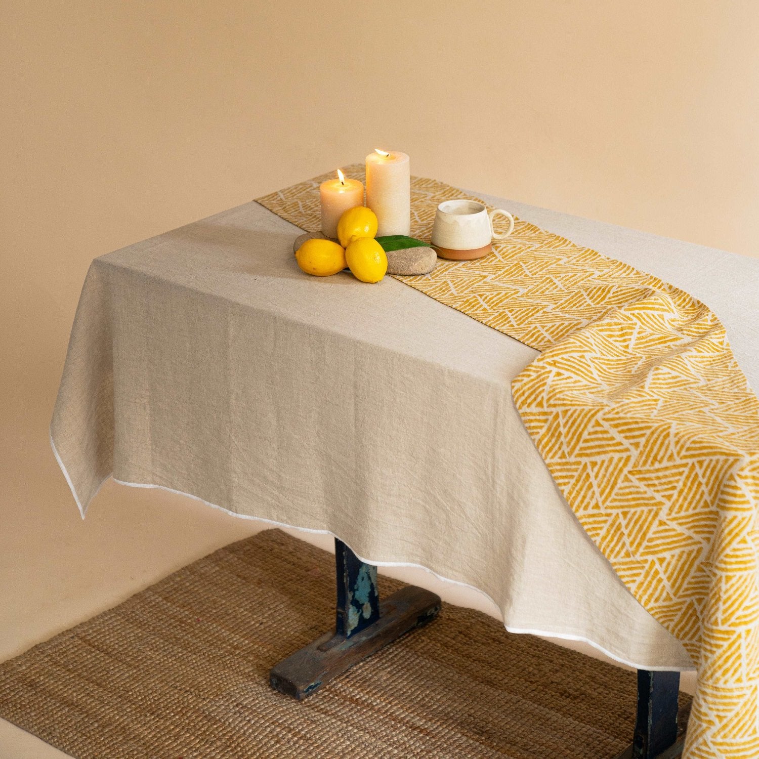 Natural linen tablecloth on a 6-seater dining table styled with minimal decor.