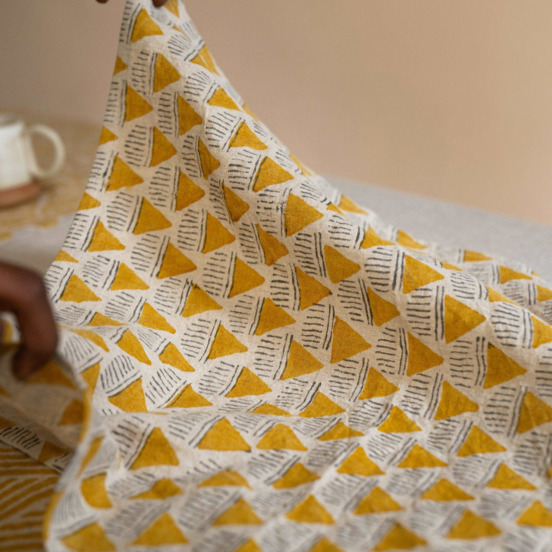 Close-up of Prisma napkin highlighting its abstract pattern, soft linen texture, and artisanal craftsmanship.