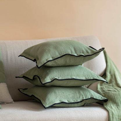 Close-up of the olive green linen cushion cover, highlighting the fabric&