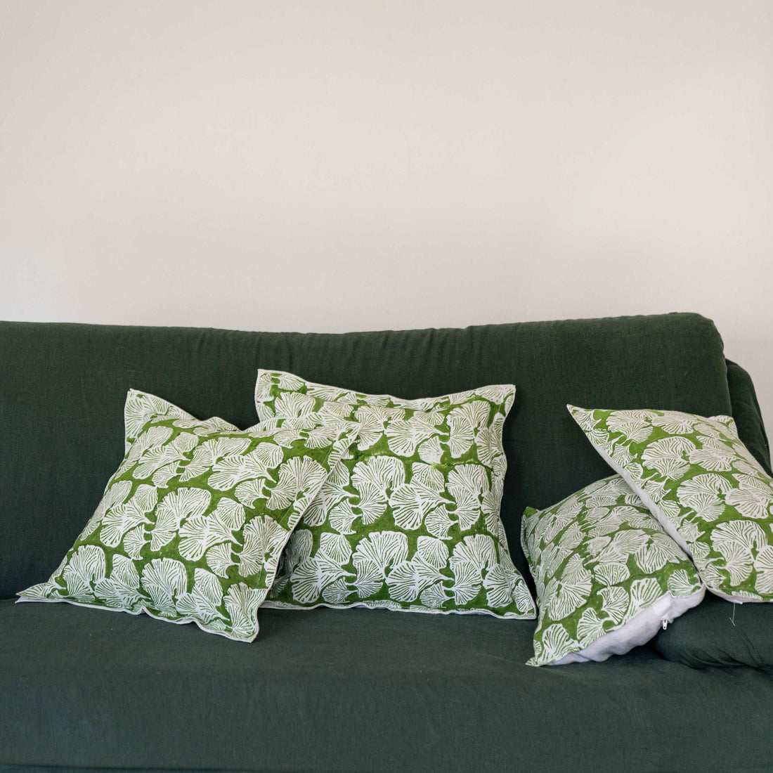 The Morel cushion cover placed on an olive sofa, adding an elegant touch to the living room décor.