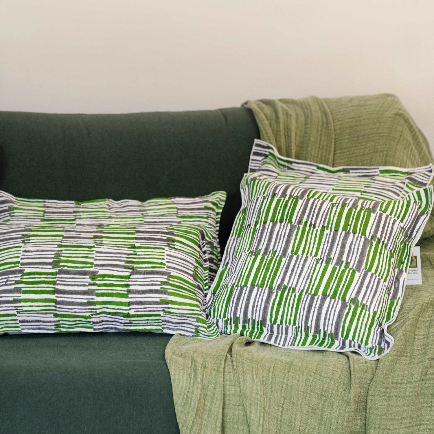 The Mosswood cushion cover styled with matching home accessories, creating a cohesive and inviting interior design.