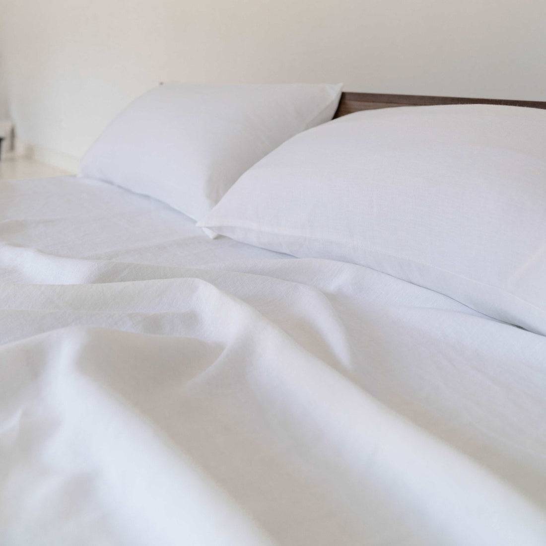 Close-up of white linen sheet showcasing its clean, breathable texture.