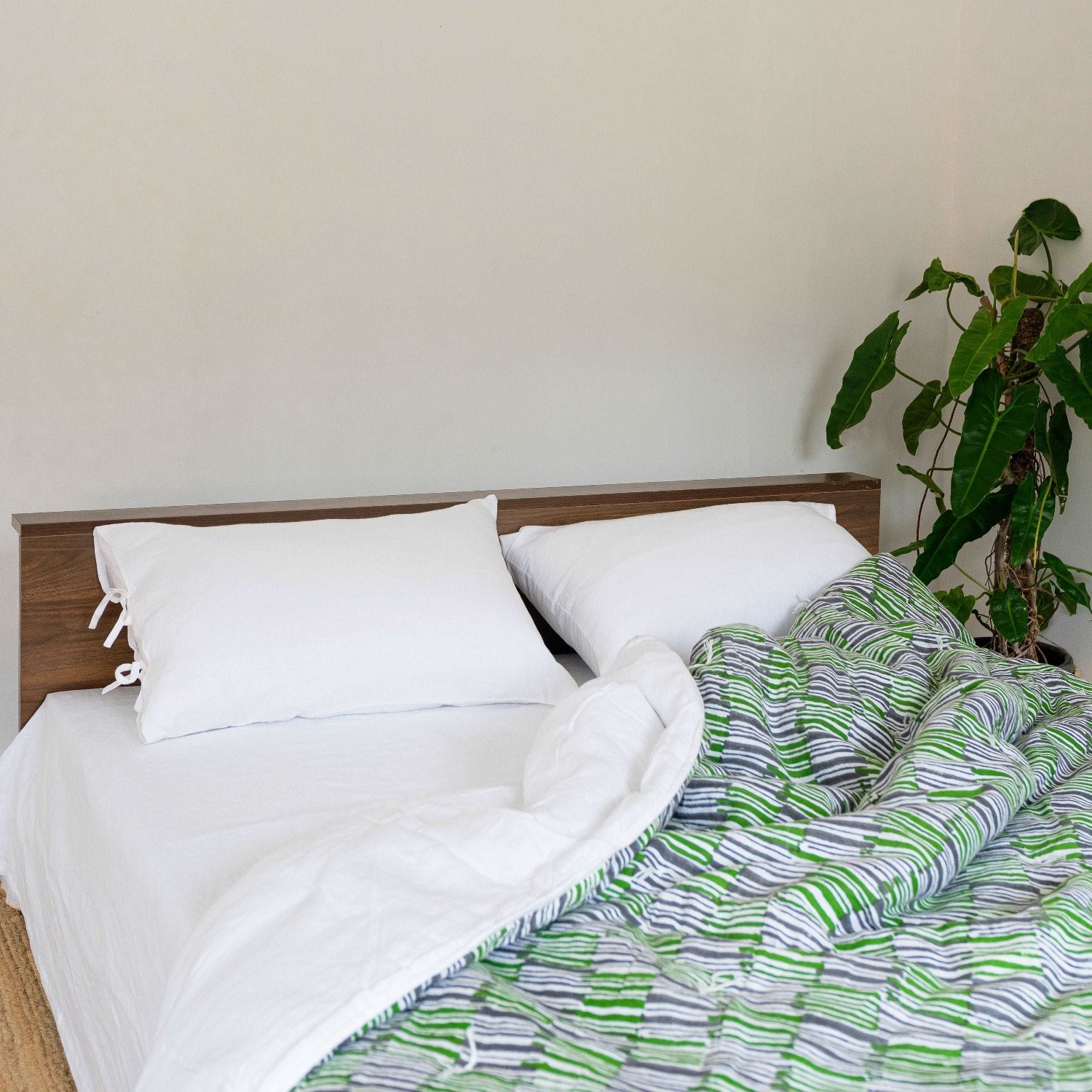 White sheet set on an unmade bed, creating a relaxed, airy feel.